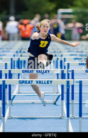 Female high school hurdler competes at the Southern Chester County League, Track & Field Championship Meet; Pennsylvania; USA Stock Photo