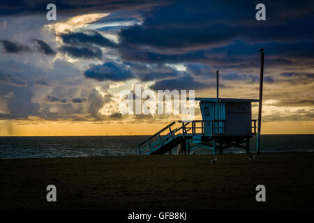 Sunset over a lifeguard tower and the Pacific Ocean, in Venice Beach, California. Stock Photo