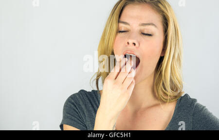 female model attractive woman on plein background with copy space bored yawning Stock Photo