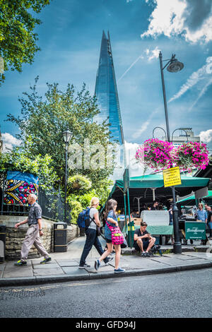 The colourful entrance to Borough Market stalls with the Shard skyscraper in the background, London, England, UK Stock Photo