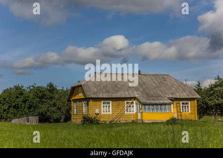 Yellow wooden house in Aukstaitija National Park, Lithuania Stock Photo