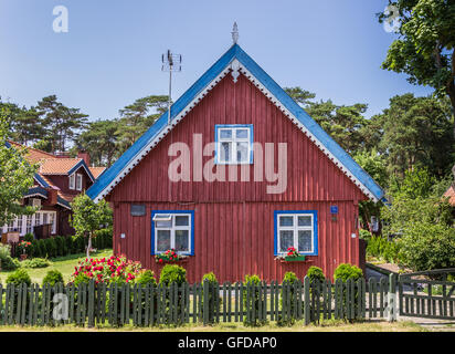 Red house with green fence on Curonian Spit, Lithuania Stock Photo