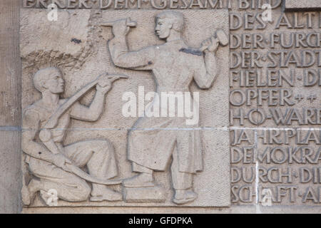 Restoration of Dresden after the Second World War after bombing attacks in February 1945. Detail of the GDR-time relief dedicated to city history at the Altmarkt (Old Market Square) in Dresden, Saxony, Germany. Stock Photo