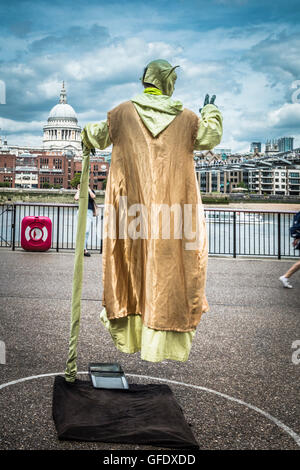 Gold painted  street performer outside of the Tate Modern on the south bank of the River Thames,  London, UK Stock Photo