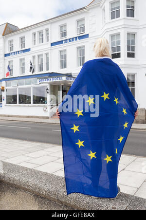 Woman with eu flag in front of Queens Hotel in Penzance, Cornwall, UK. Stock Photo