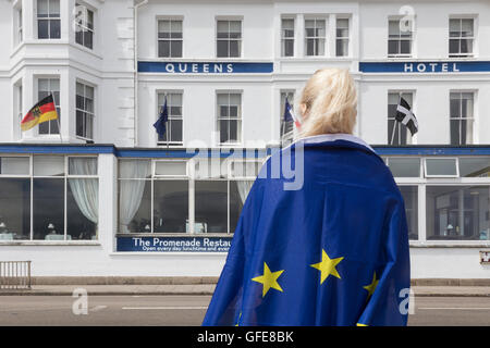 Woman with eu flag in front of Queens Hotel in Penzance, Cornwall, UK. Stock Photo