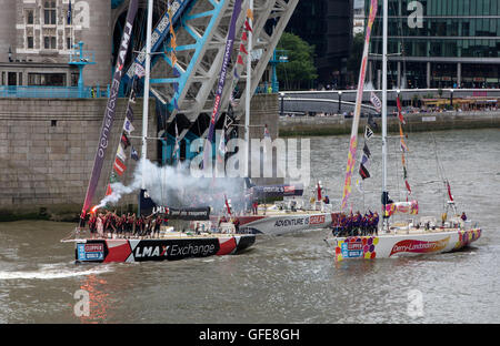 The LMAX Exchange team lights a flare as it wins the race, followed by Team Derry Londonderry Derry and Team Great Britain and Northern Ireland in third place, during the final stage of the Clipper Round the World Yacht Race at St Katharine Docks, London. PRESS ASSOCIATION Photo. Picture date: Saturday July 30, 2016. Photo credit should read: Simon Cooper/PA Wire Stock Photo