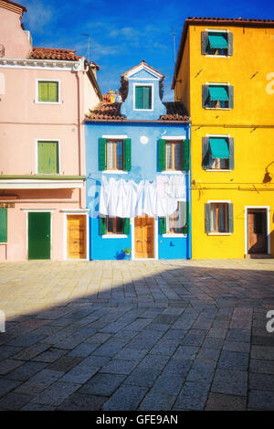 Hung laundry on the lines in front of houses in Burano. Stock Photo