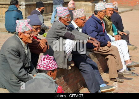 Nepalese men gathering and wearing Dhaka Topi (traditional Nepalese hat) at Durbar Square in Patan, Nepal Stock Photo