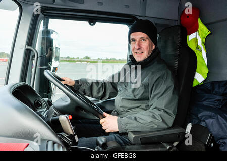 A lorry driver at the wheel. Stock Photo