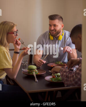 Happy friends in vegan restaurant Stock Photo