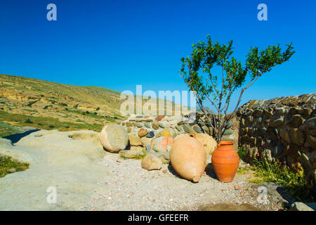 Ceramic ancient amphora for wine on a background of mountains outdoors Stock Photo
