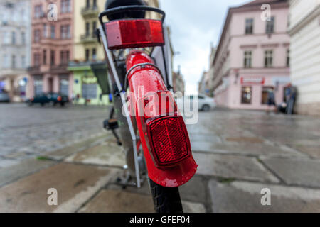 Bicycle with red fender. Square on a rainy day on city scenery bike close up Stock Photo