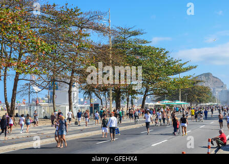 Pedestrians relax on Copacabana Beach which closes the main road to pedestrians. Rio de Janeiro is hosting the Olympics 2016 Stock Photo
