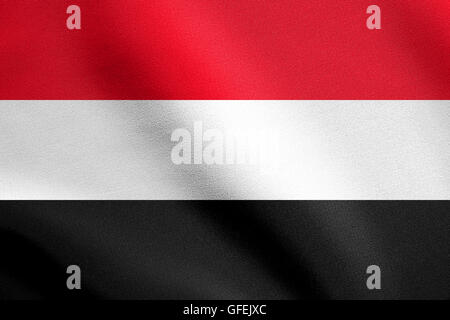 Flag of Yemen waving in the wind with detailed fabric texture. Yemeni national flag. Stock Photo