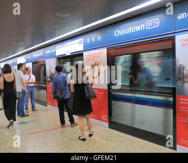 People commute at Chinatown MRT Station in Singapore. Stock Photo