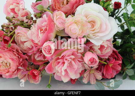 Silk rose flower bouquet on white background Stock Photo