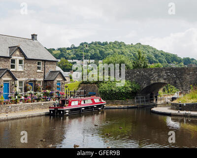 Tranquil moment at Brecon Basin on the Monmouth and Brecon Canal with moored narrow boat hire cruiser. Stock Photo