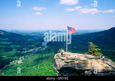 Union US flag on Chimney Rock overlook viewpoint landmark in Chimney Rock Park above Lake Lure North Carolina USA Stock Photo