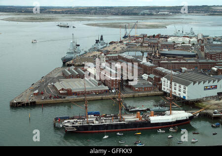 A general view of Portsmouth Naval Base and dockyard with the Type 45 destroyers HMS Dragon (left), HMS Diamond (second left) and HMS Daring (right, at rear) in dock, as the Ministry of Defence has said that all of the Royal Navy's most powerful warships are in port at the same time. Stock Photo
