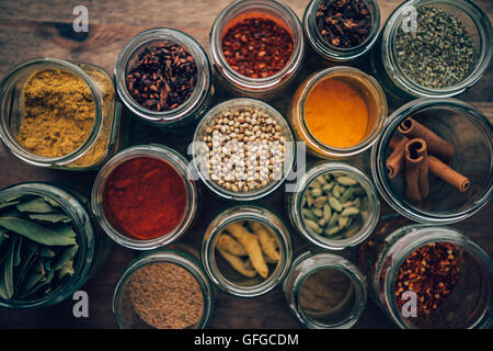 Assortment of colorful spices in glass jars. Stock Photo