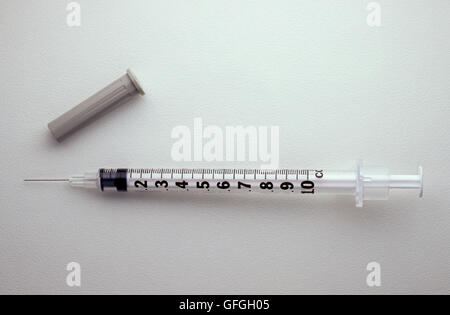 A simple shot of a injection syringe on a graduated gray background Stock Photo