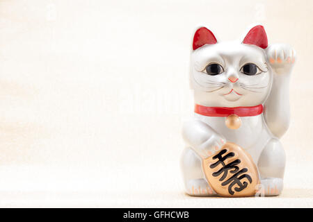 Japanese silver beckoning cat called Manekineko also known as a lucky cat Stock Photo