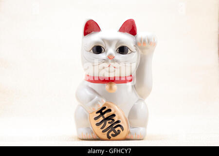 Japanese silver beckoning cat called Manekineko also known as a lucky cat Stock Photo