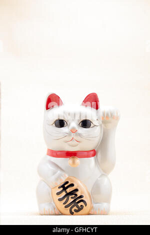 Japanese silver beckoning cat called Manekineko also known as a lucky cat Stock Photo