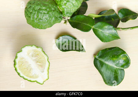 Bergamot (Also known as Kaffir lime, Citrus lime, Magnoliophyta Rutaceae) fruits and half cross section with leaf isolated on wo Stock Photo