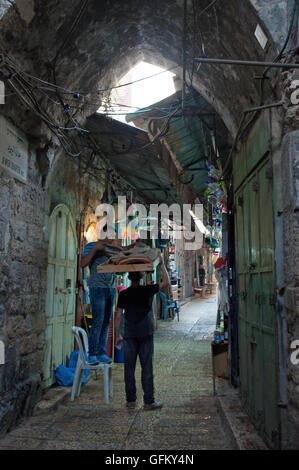 Jerusalem: people in the alleys of the Old City, a walled area in which live together Muslims, Jews, Catholics and Armenians Stock Photo