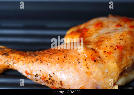 Chicken leg with Piri Piri marinade on an electric grill Stock Photo