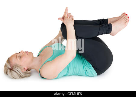On the back of this young woman in the sport dress covers your knees with your hands with closed eyes on a white background. Stock Photo