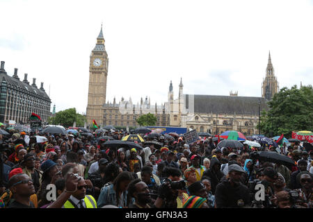 London, UK. 1st Aug, 2016. Stop the Maangamizi'(African Holocaust ) Thousands of people with banners and placards march from Brixton to Parliament Square on to mark Emancipation Day and reiterate calls for reparations. Emancipation Day – a national holiday in many former British colonies in the Caribbean is the anniversary of the 1833 Slavery Abolition Act, which made slavery illegal from August 28, 1834. Credit:  Thabo Jaiyesimi/Alamy Live News Stock Photo