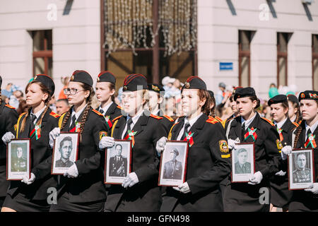 The Marching Formation Of Cadet Girls From Gomel State Cadet School With Portraits Of WW2 Heroes In Ceremonial Parade Procession Stock Photo