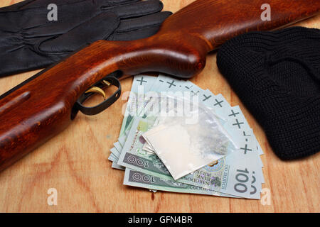 Bags of drugs,  euro money and gun on a wooden table Stock Photo