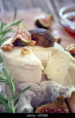 Ricotta with ripe sliced fig fruits, nuts and honey Stock Photo