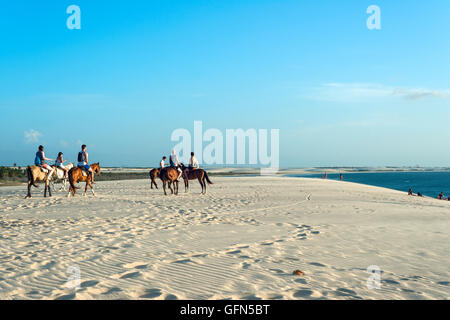Jericoacoara, Ceara state, Brazil - July 18, 2016: Tourists ride on horseback at Sunset Dune about an hour before sunset Stock Photo