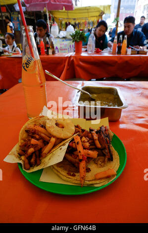 Lagunilla Market restaurant in Mexico City, Mexico. Tacos and soft drink. Stock Photo