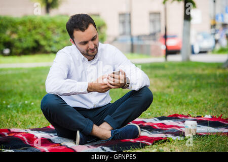 young businessman at the park working with tablet Stock Photo