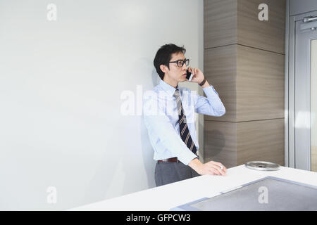 Japanese businessman in smoking room Stock Photo