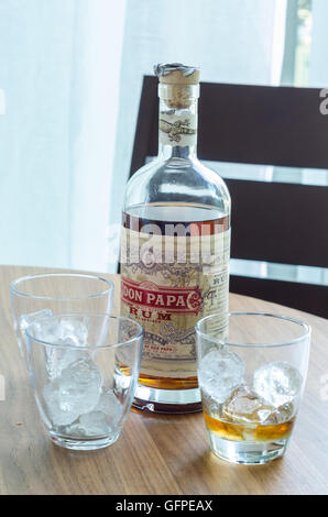 A bottle of rum an sum glasses with ice. Stock Photo