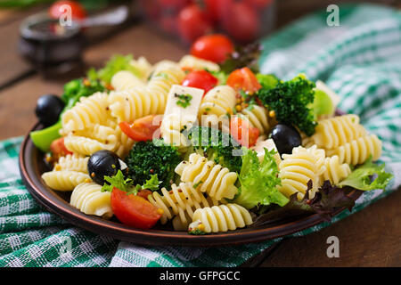 Pasta salad with tomato, broccoli, black olives,  and cheese feta Stock Photo