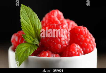 Ripe sweet raspberries in bowl Stock Photo