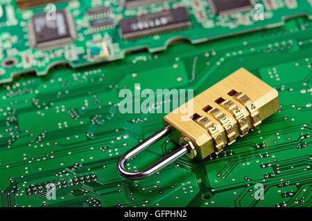 Computer Hardware security concept. Lock over circuit board Stock Photo
