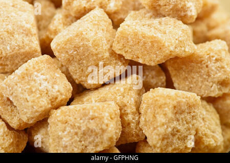 Brown cane sugar as background Stock Photo