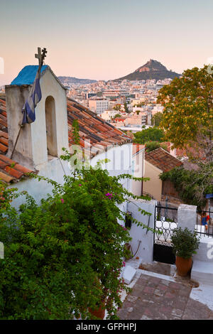 View of Lycabettus hill and a small Greek orthodox church in Anafiotika, Athens. Stock Photo