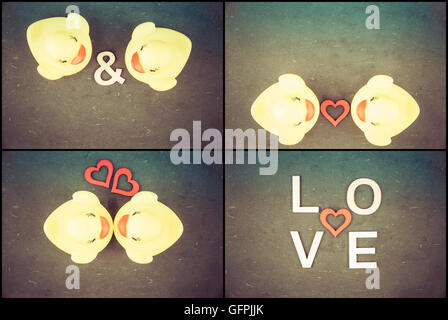 Photo Collage of Pair of yellow rubber ducks isolated over black chalkboard background and red heart shape between Stock Photo