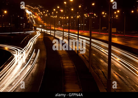 A night time shot of speeding traffic on a road Stock Photo