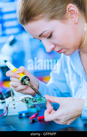 Soldering of electronic  controller Stock Photo